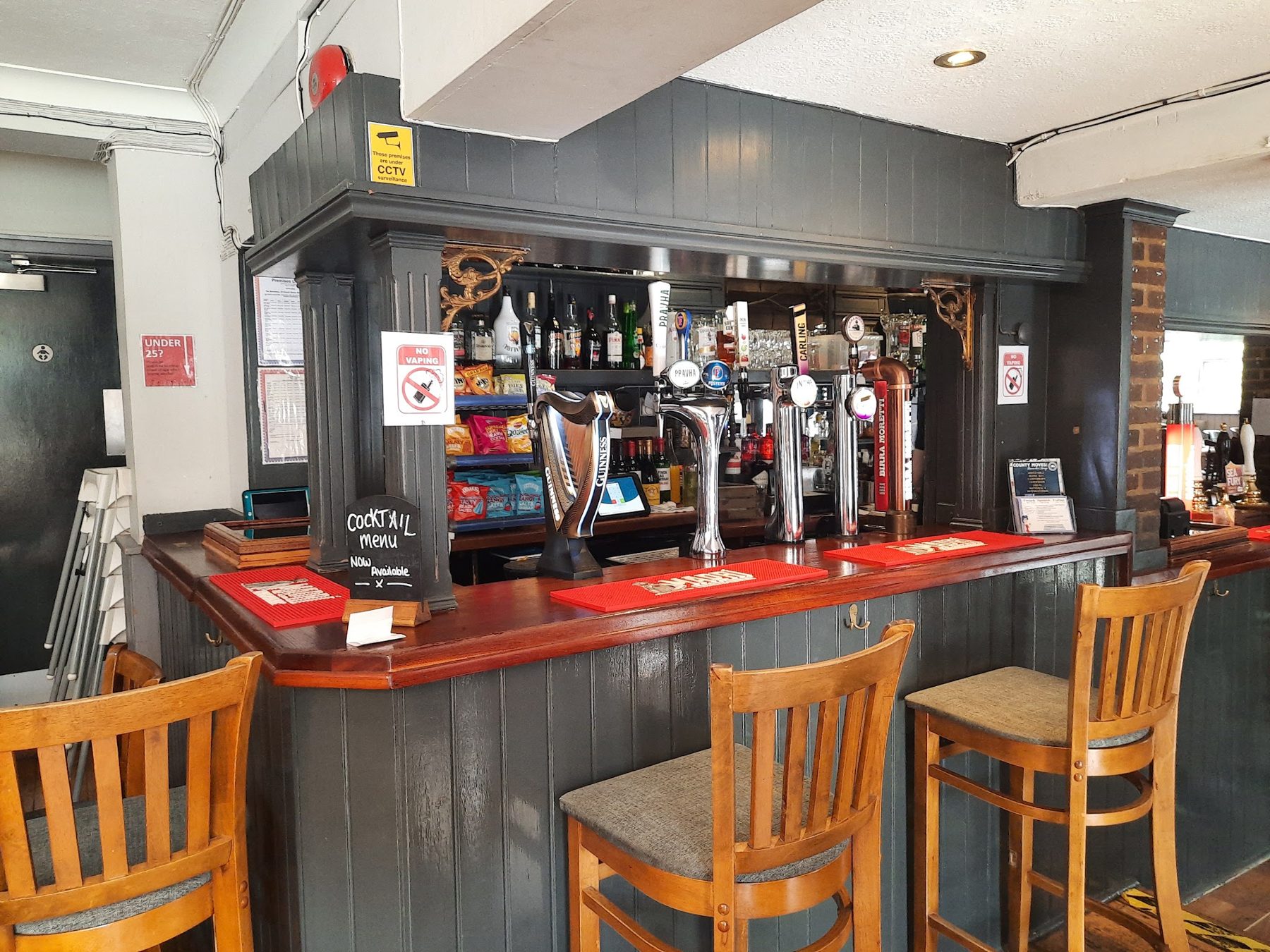 The bar, with beer pumps and wooden stools