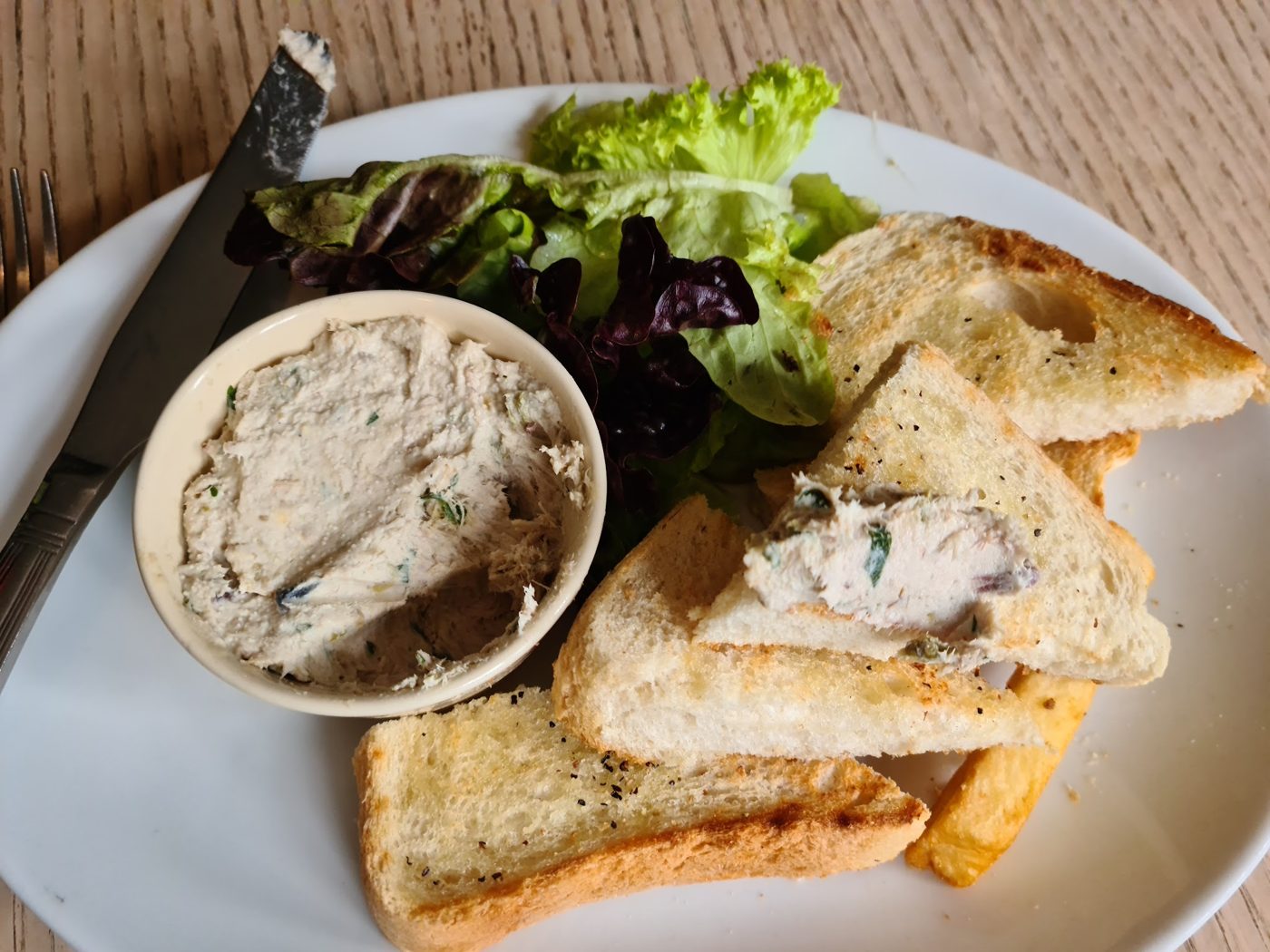 Pâté with toast and salad leaves